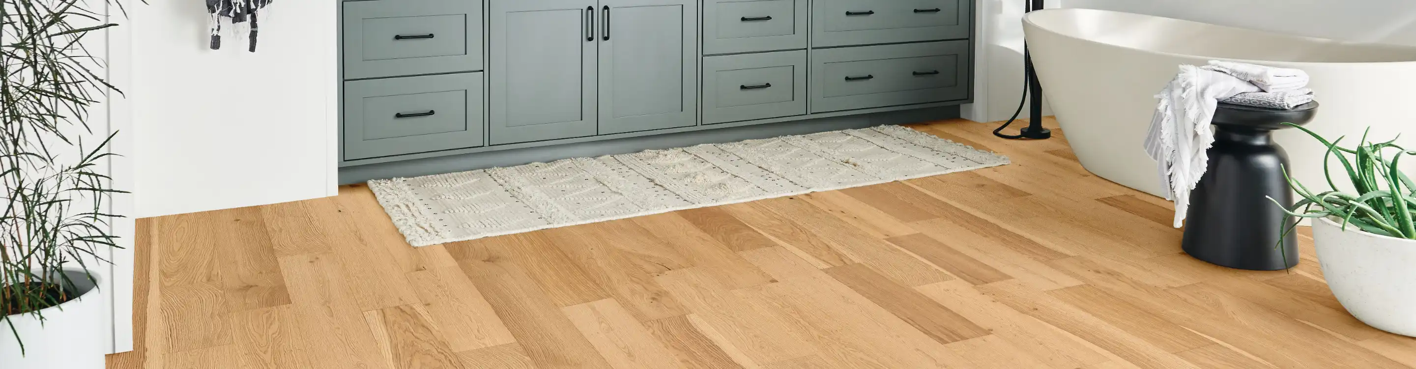 Modern bathroom featuring dark brown laminate flooring with a realistic wood-look design.